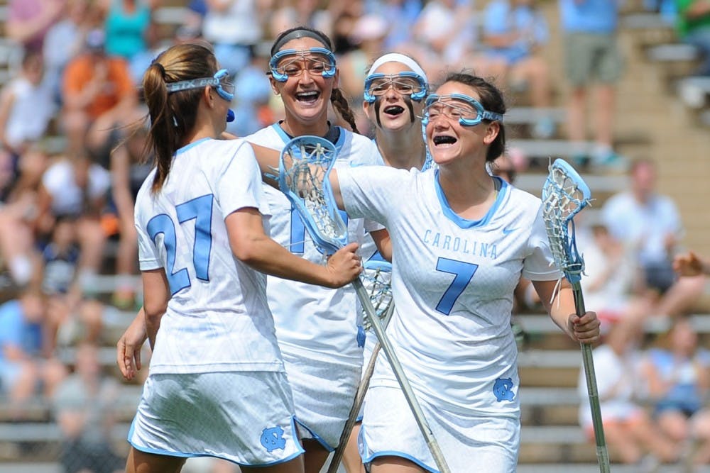 UNC attackers Aly Messinger (27), Sydney Holman (10), Molly Hendrick (20), and Am McGee (7) celebrate after defeating Maryland 17-15.