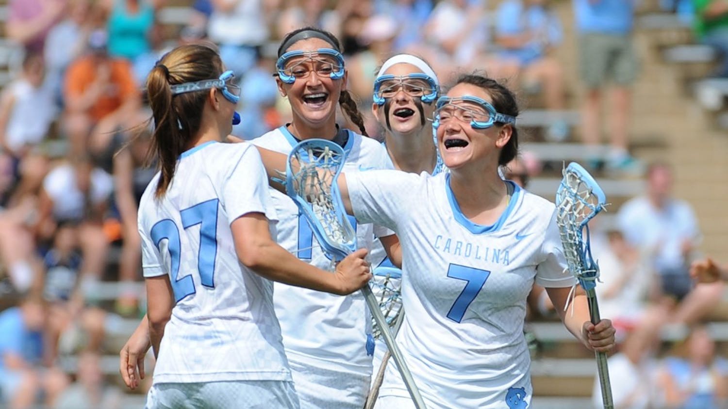 UNC attackers Aly Messinger (27), Sydney Holman (10), Molly Hendrick (20), and Am McGee (7) celebrate after defeating Maryland 17-15.