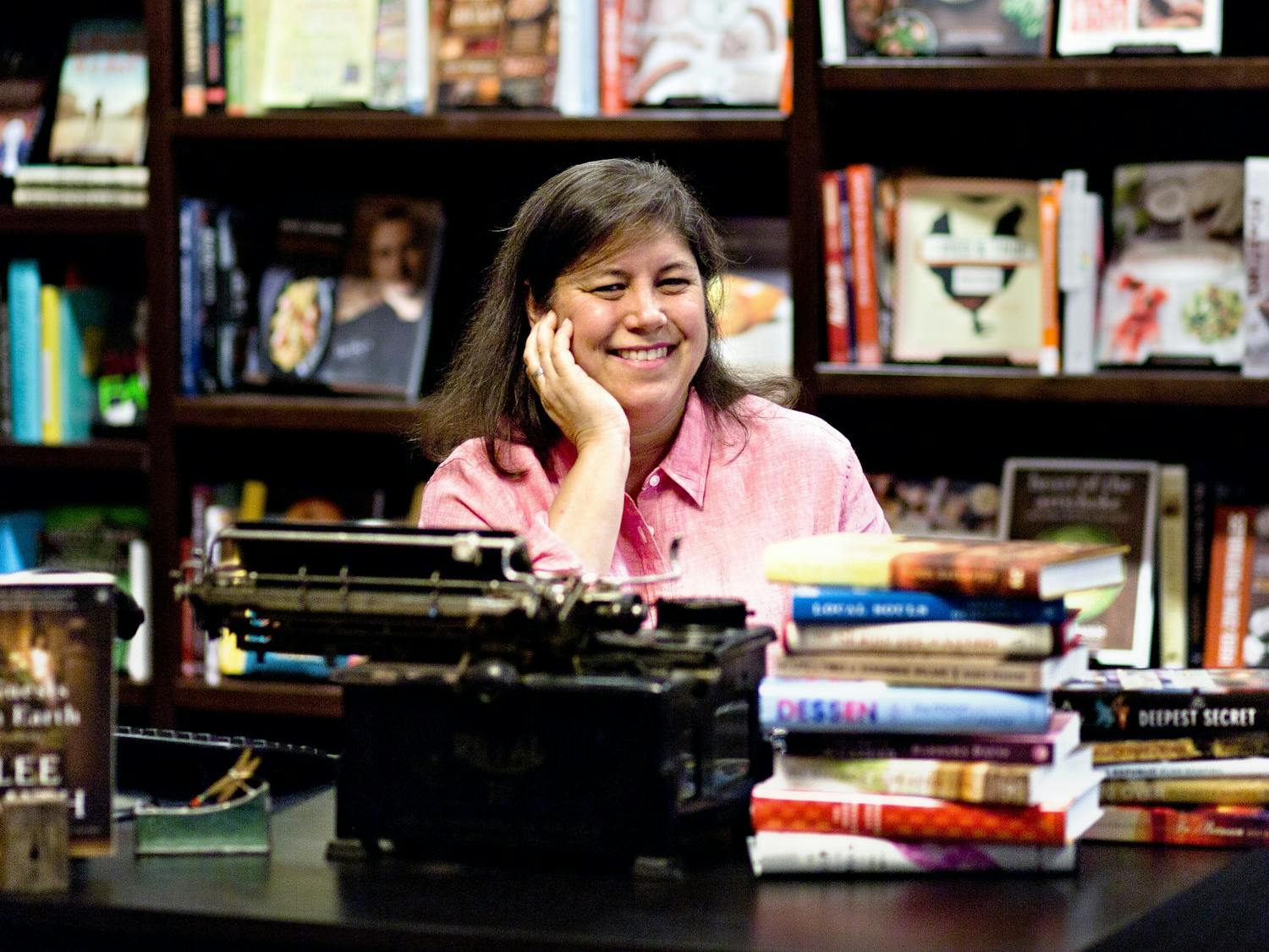 Jamie Fiocco, owner and general manager of Flyleaf Books, poses for a portrait at her bookstore. Photo courtesy of Jamie Fiocco. 