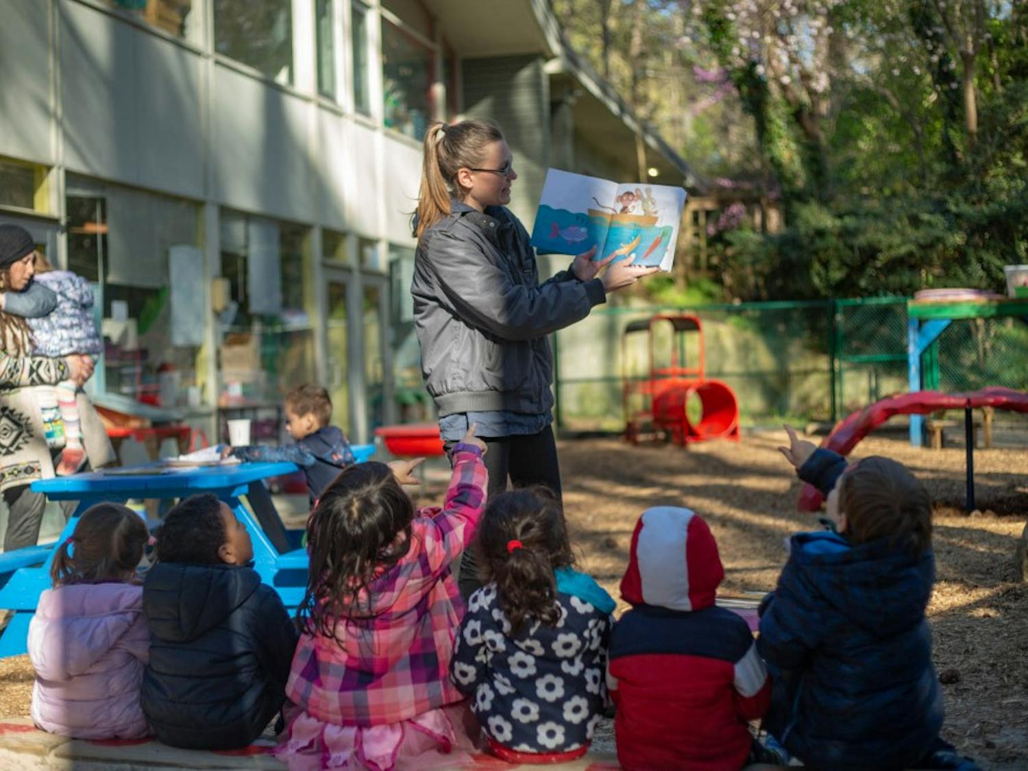 Eppie Landis (Center), a blue room teacher, reads for students at the Chapel Hill Cooperative Preschool on Monday, April 1st. The Cooperative Preschool system also finalized plans to consolidate their two Chapel Hill sites into a single facility on Monday, April 1, 2019.