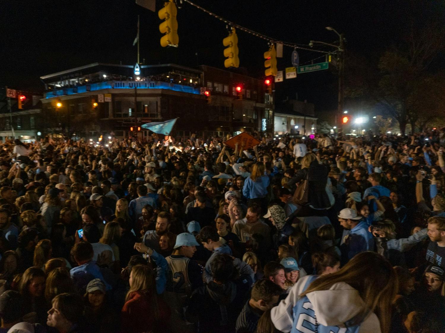 North Carolina men's basketball fans rush Franklin St. after a historic win over Duke in the Final Four game on Saturday, Apr. 2, 2022. UNC won 81-77.
