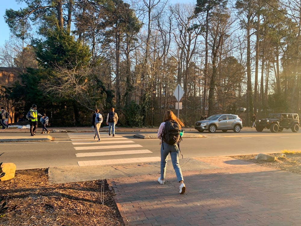 Students cross South road on the campus of the University of North Carolina at Chapel Hill on Jan. 25, 2022.