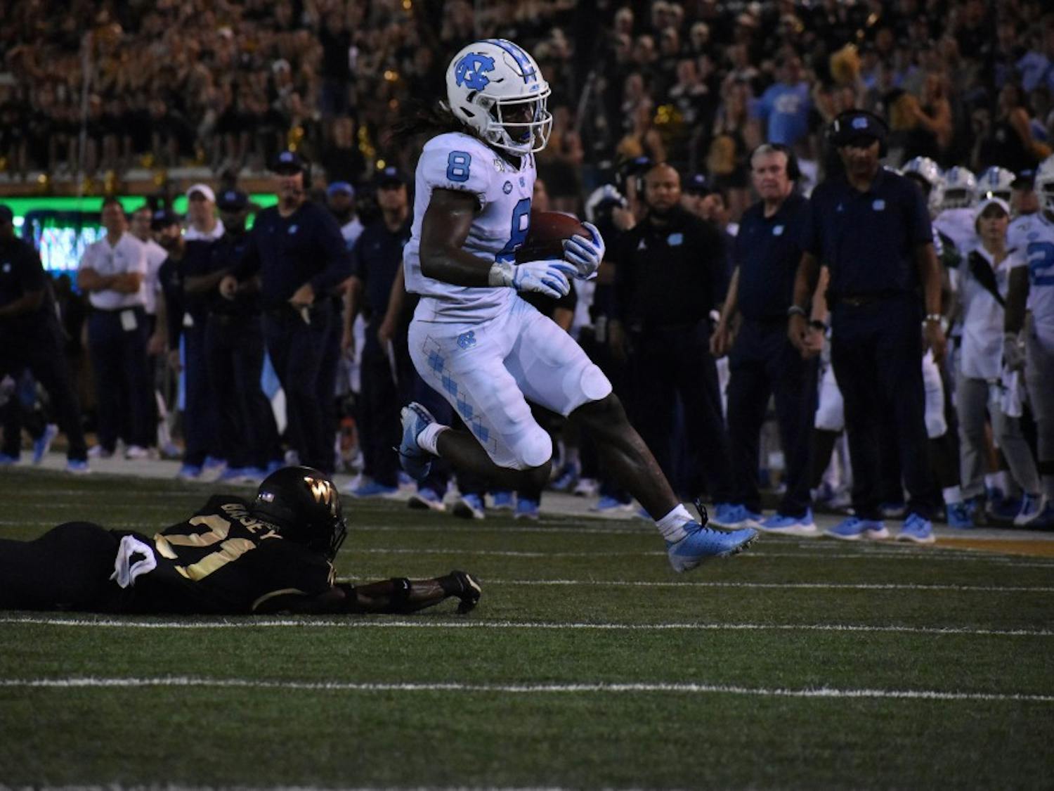 UNC-CH junior running back Michael Carter (#8) running the football in the loss against Wake Forest. 
