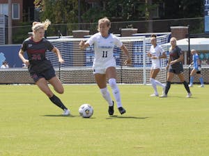 UNC freshman midfielder Lauren Wrigley (11) chases the ball against Stanford senior forward Abby Gruebel (24) on Sept. 5, 2021. UNC won in overtime 2-1.