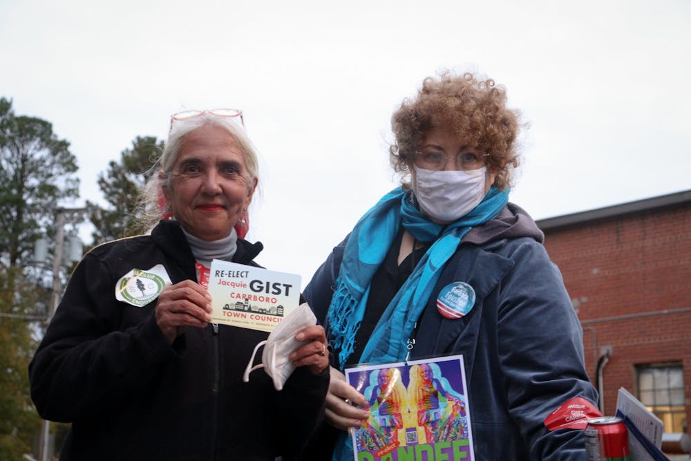 <p>Former Carrboro Town Council member Jacquelyn Gist (left) and Carrboro resident Jacqueline Marx campaign outside Carrboro Town Hall on Nov. 2, 2021.</p>
