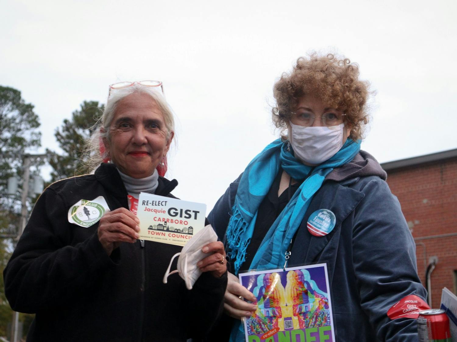 Former Carrboro Town Council member Jacquelyn Gist (left) and Carrboro resident Jacqueline Marx campaign outside Carrboro Town Hall on Nov. 2, 2021.