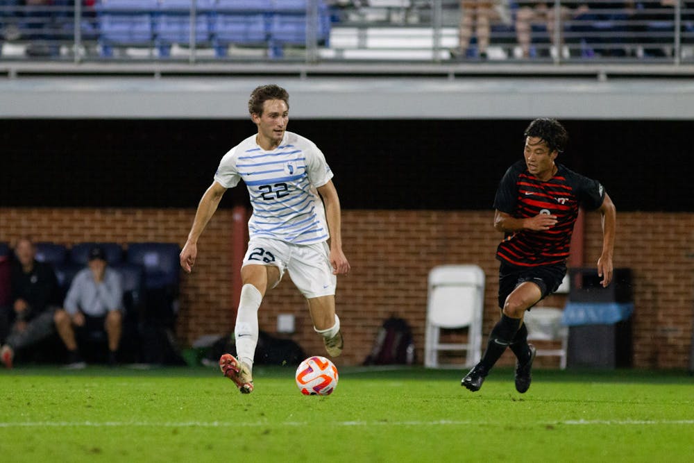 <p>Graduate midfielder/defender Milo Garvanian (22) dribbles the ball at the UNC vs. VT game on Friday, Oct. 7, 2022, in Chapel Hill. The Tar Heels won 2-0.</p>