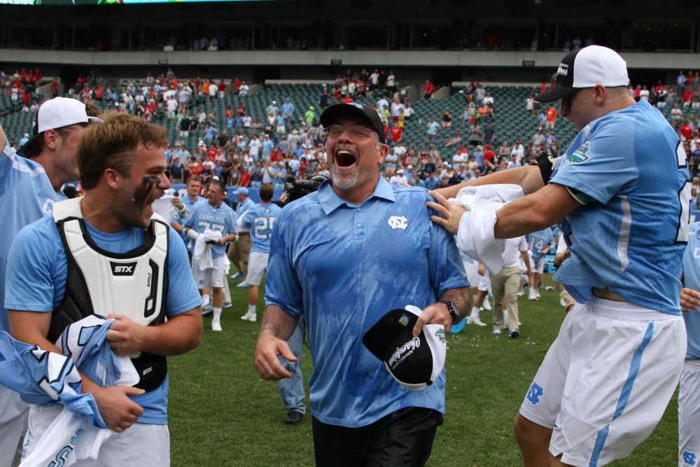 UNC men's lacrosse coach Joe Breschi runs towards his players after being given a gatorade bath.&nbsp;The unseeded North Carolina men's lacrosse team defeated No. 1 Maryland 14-13 in overtime to claim the program's first national championship since 1993 on Monday at Lincoln Financial Field in Philadelphia.