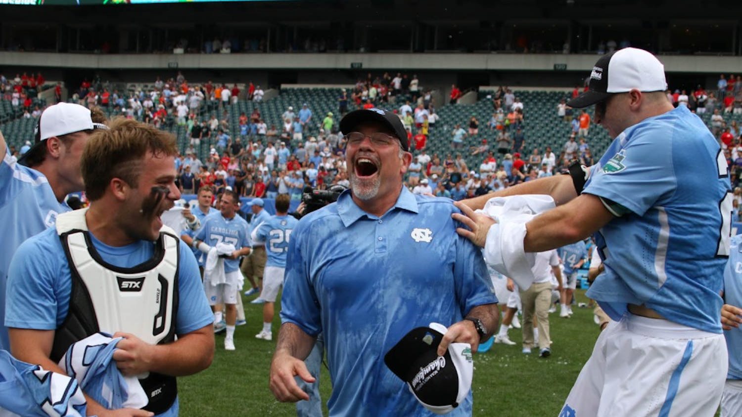 UNC men's lacrosse coach Joe Breschi runs towards his players after being given a gatorade bath.&nbsp;The unseeded North Carolina men's lacrosse team defeated No. 1 Maryland 14-13 in overtime to claim the program's first national championship since 1993 on Monday at Lincoln Financial Field in Philadelphia.