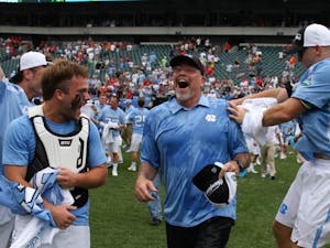UNC men's lacrosse coach Joe Breschi runs towards his players after being given a gatorade bath.&nbsp;The unseeded North Carolina men's lacrosse team defeated No. 1 Maryland 14-13 in overtime to claim the program's first national championship since 1993 on Monday at Lincoln Financial Field in Philadelphia.