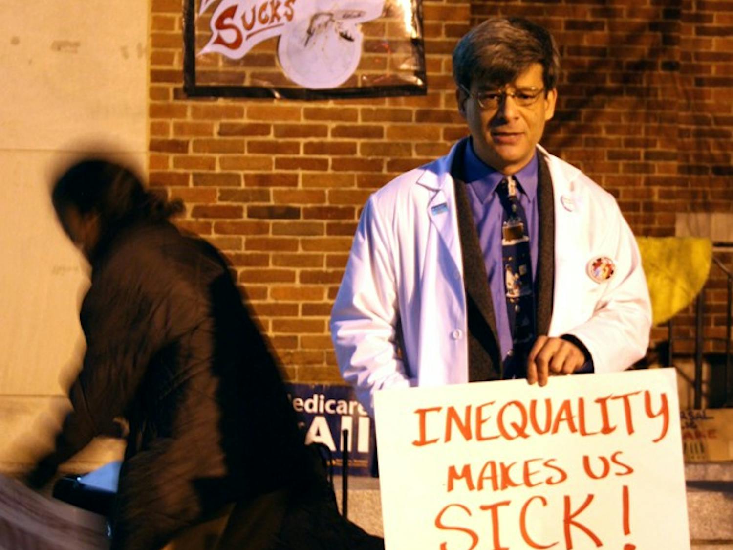 Dr. Steve Auerbach spoke on saturday about "Winning Health Care for the 99%" in front of the post office for Occupy Chapel Hill.Auerbach- white lab coat. Dr. Jonathan Kotch- hat and mustache- professor at UNC, president of Health Care for all NC. Katya Roytburd- holding sign saying "single payer"- helped organize the event with Kotch