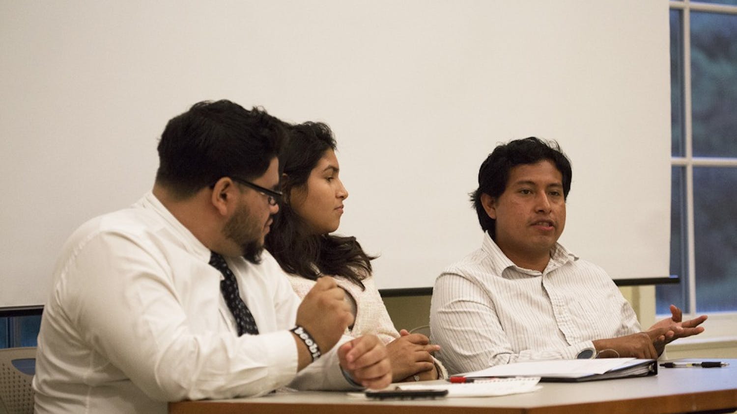 Carolina Hispanic Association (CHipsA) panelists Manny Amaya, left, Cecilia Polanco, and Emilio Vicente speak to members of the UNC-Chapel Hill chapter of the NAACP in the Upendo Lounge at SASB North.