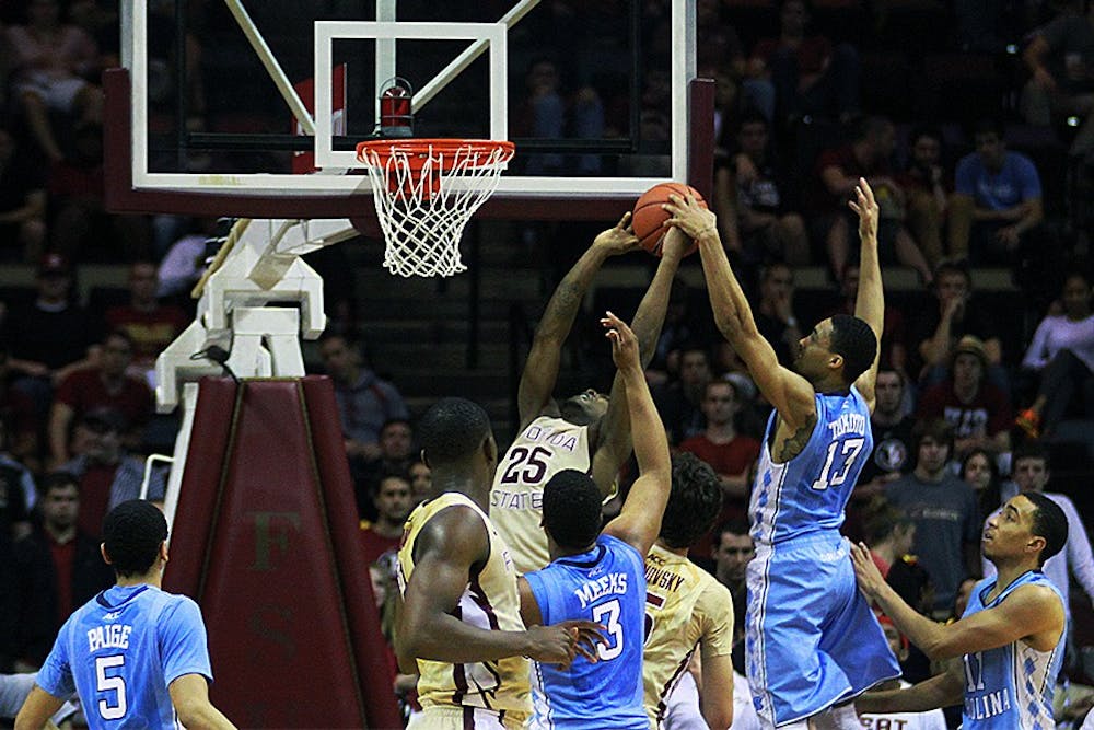 	JP Tokoto (13) blocks a shot attempt from Florida State&#8217;s Aaron Thomas (25). This was Tokoto&#8217;s only block for the night.
