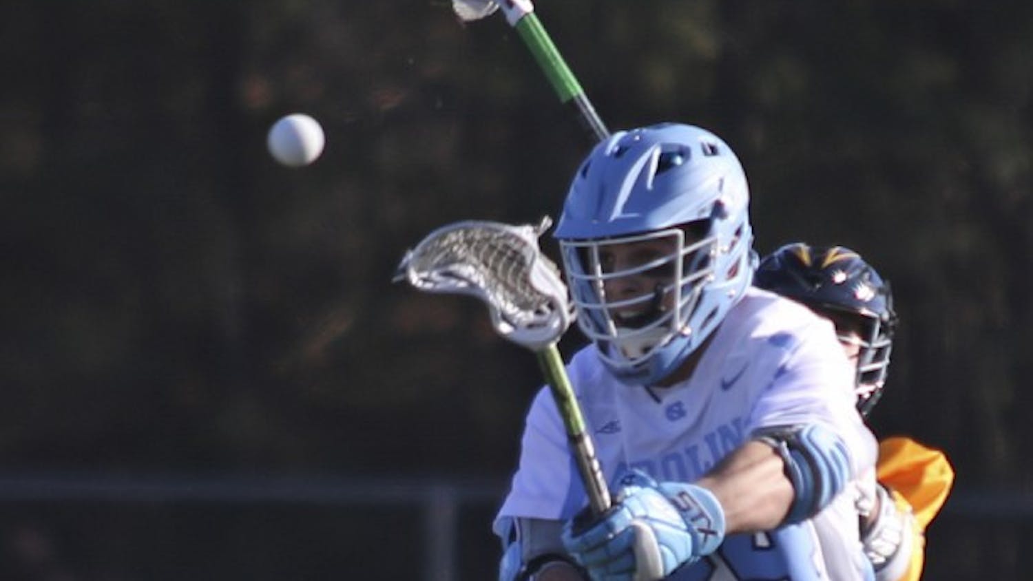 UNC midfielder Stephen Kelly (24) fires a shot after winning a face-off against UMBC on Saturday at Cardinal Gibbons High School in Raleigh.