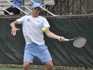 First-year Brian Cernoch hits a forehand during UNC's match against Florida State on Sunday, March 31, 2019. The Heels beat the Seminoles 6-1.