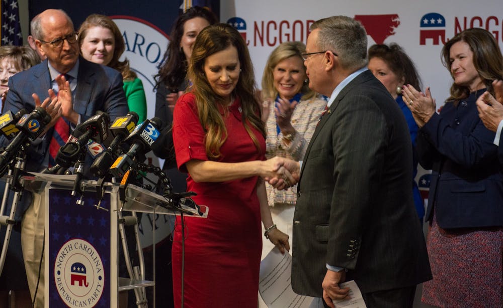 <p>North Carolina Rep. Tricia Cotham (R-Mecklenburg) shakes the hand of N.C. House Speaker Tim Moore (R-Cleveland, Rutherford) at the N.C. GOP Headquarters in Raleigh, N.C., after she officially announced her change in party afflilation. Cotham was previously a Democrat until her announcement on Wednesday, April 5.</p>