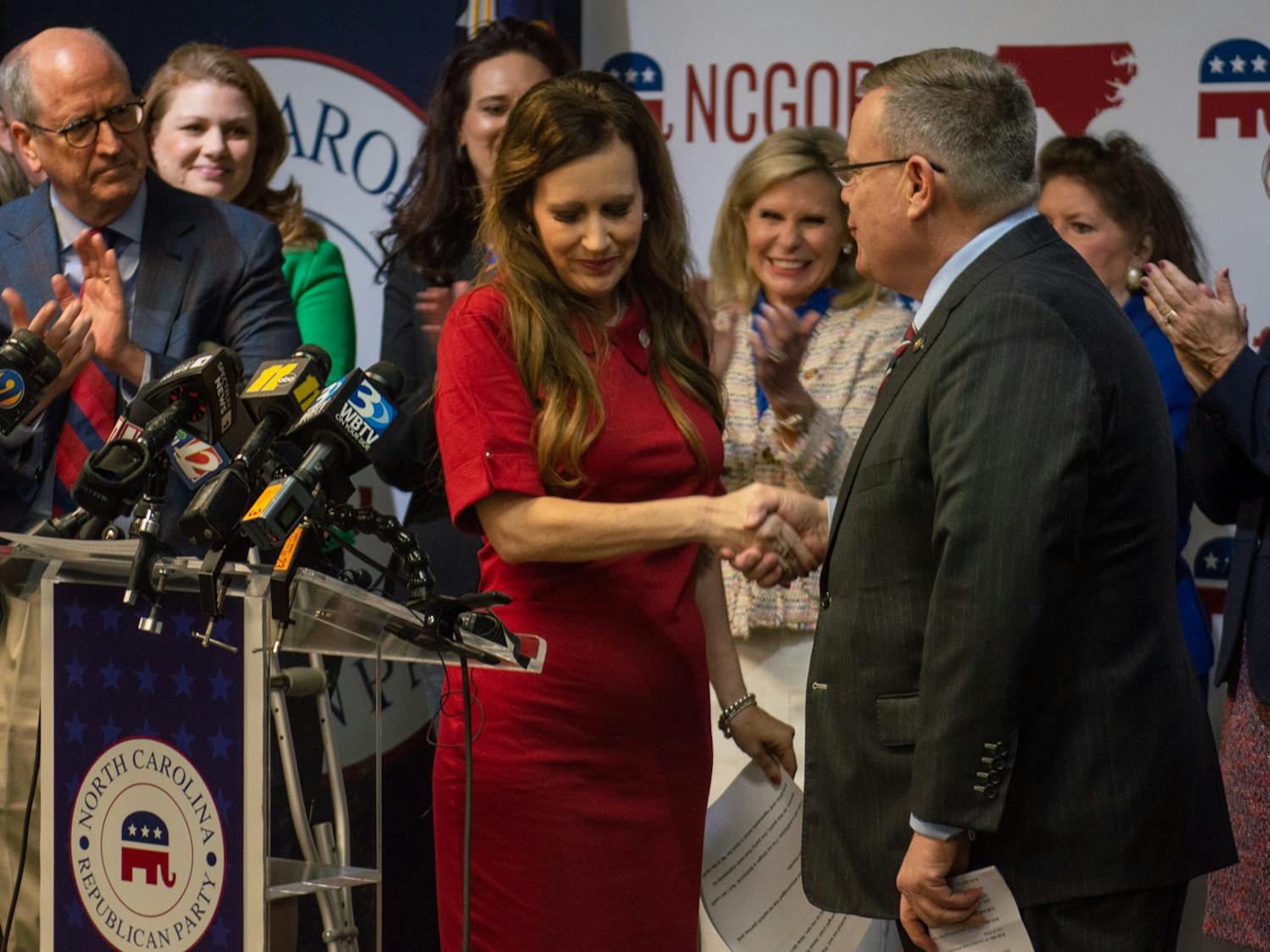 North Carolina Rep. Tricia Cotham (R-Mecklenburg) shakes the hand of N.C. House Speaker Tim Moore (R-Cleveland, Rutherford) at the N.C. GOP Headquarters in Raleigh, N.C., after she officially announced her change in party afflilation. Cotham was previously a Democrat until her announcement on Wednesday, April 5.