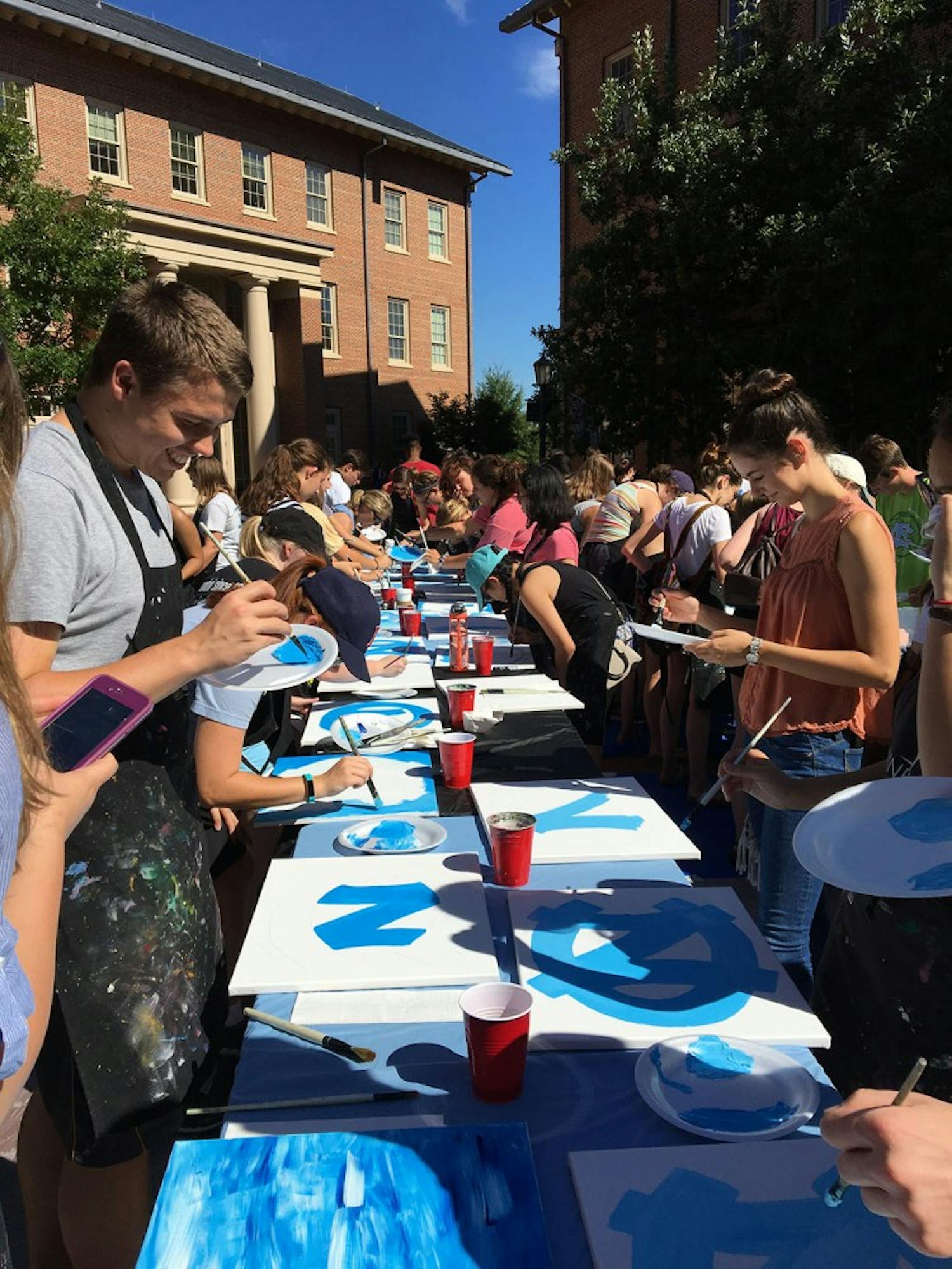 Students partake in "Paint a Picture of Your Carolina",&nbsp;a Week of Welcome event, led by the&nbsp;Wine & Design group.&nbsp;Photo Courtesy of Roslyn Sloop-Troutman.