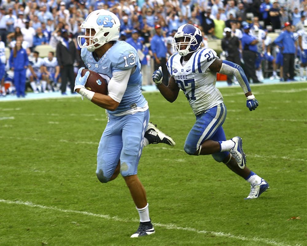 Mack Hollins (13) runs the ball downfield for a touchdown during the UNC vs. Duke game Saturday.