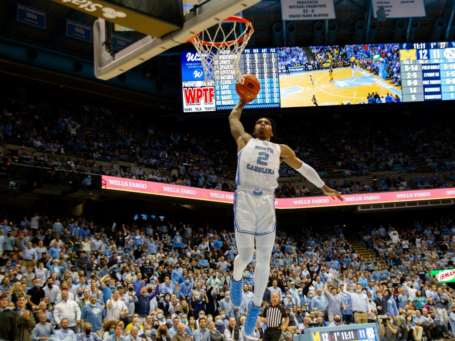 Sophomore guard Caleb Love (2) goes up for a dunk on a quick break during UNC basketball's home game against Michigan on Wednesday, Dec. 1, 2021.