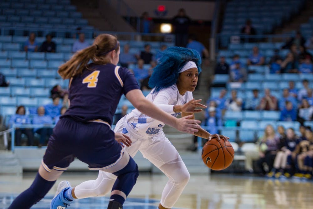 Senior guard Madinah Muhammad (3) dodges around Navy player in the women's basketball game against Navy in the Carmichael Arena on Monday, Nov. 11, 2019. UNC won 80-40.
