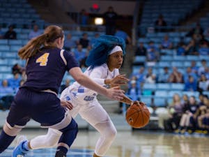 Senior guard Madinah Muhammad (3) dodges around Navy player in the women's basketball game against Navy in the Carmichael Arena on Monday, Nov. 11, 2019. UNC won 80-40.