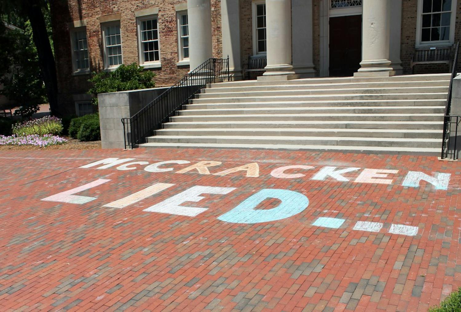 On July 11, protestors chalked "McCracken Lied" on the bricks in front of South Building. 