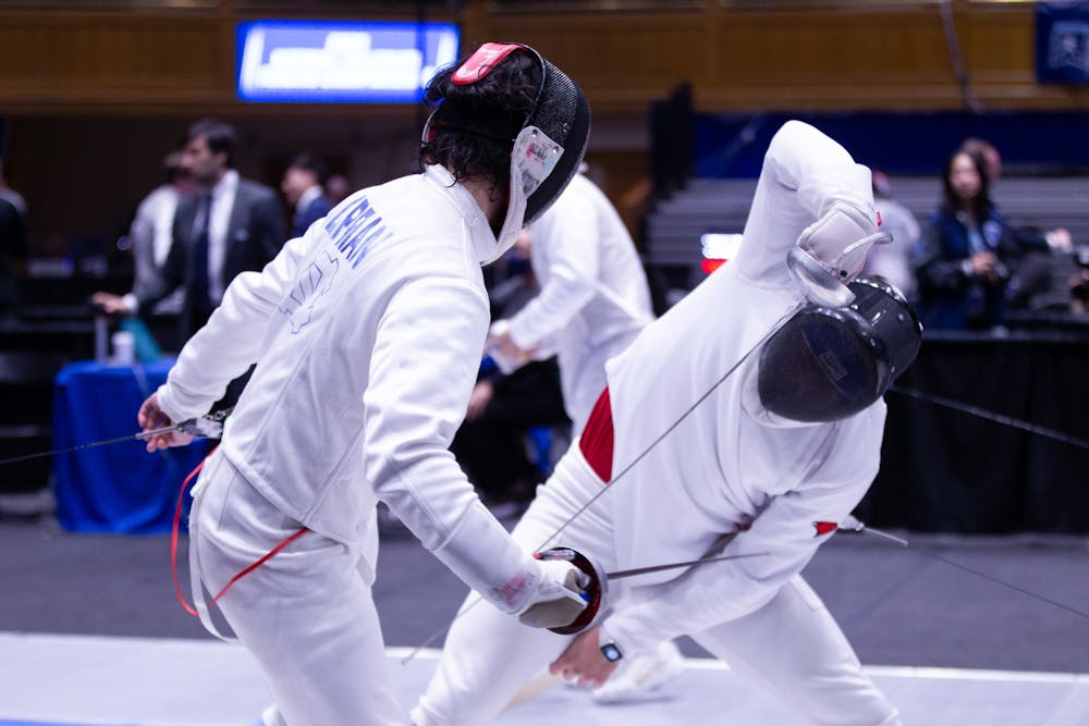 <p>UNC sophomore epee/right hand Eli Lippman fences during the NCAA Fencing Championships at Cameron Indoor Stadium in Durham, N.C., on Friday, March 24, 2023.</p>