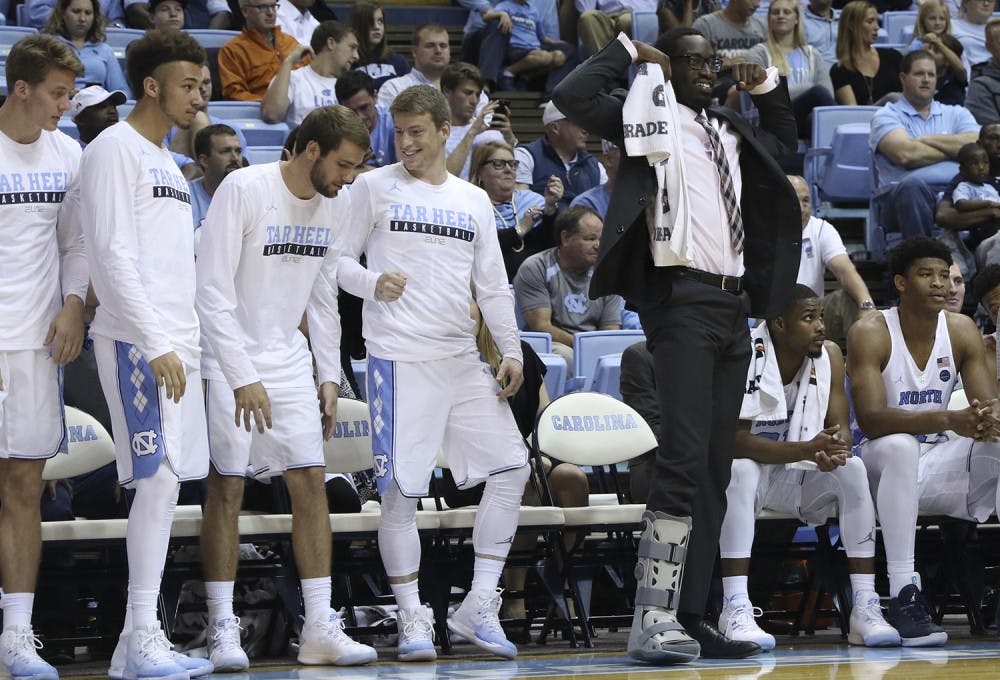<p>UNC forward Theo Pinson (right) celebrates after a teammate made a shot in the men's basketball team's game against UNC-Pembroke.</p>