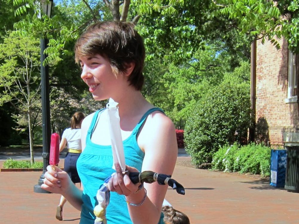 	A Campus Y member enjoys a popsicle while waiting to finish tie-dying. 