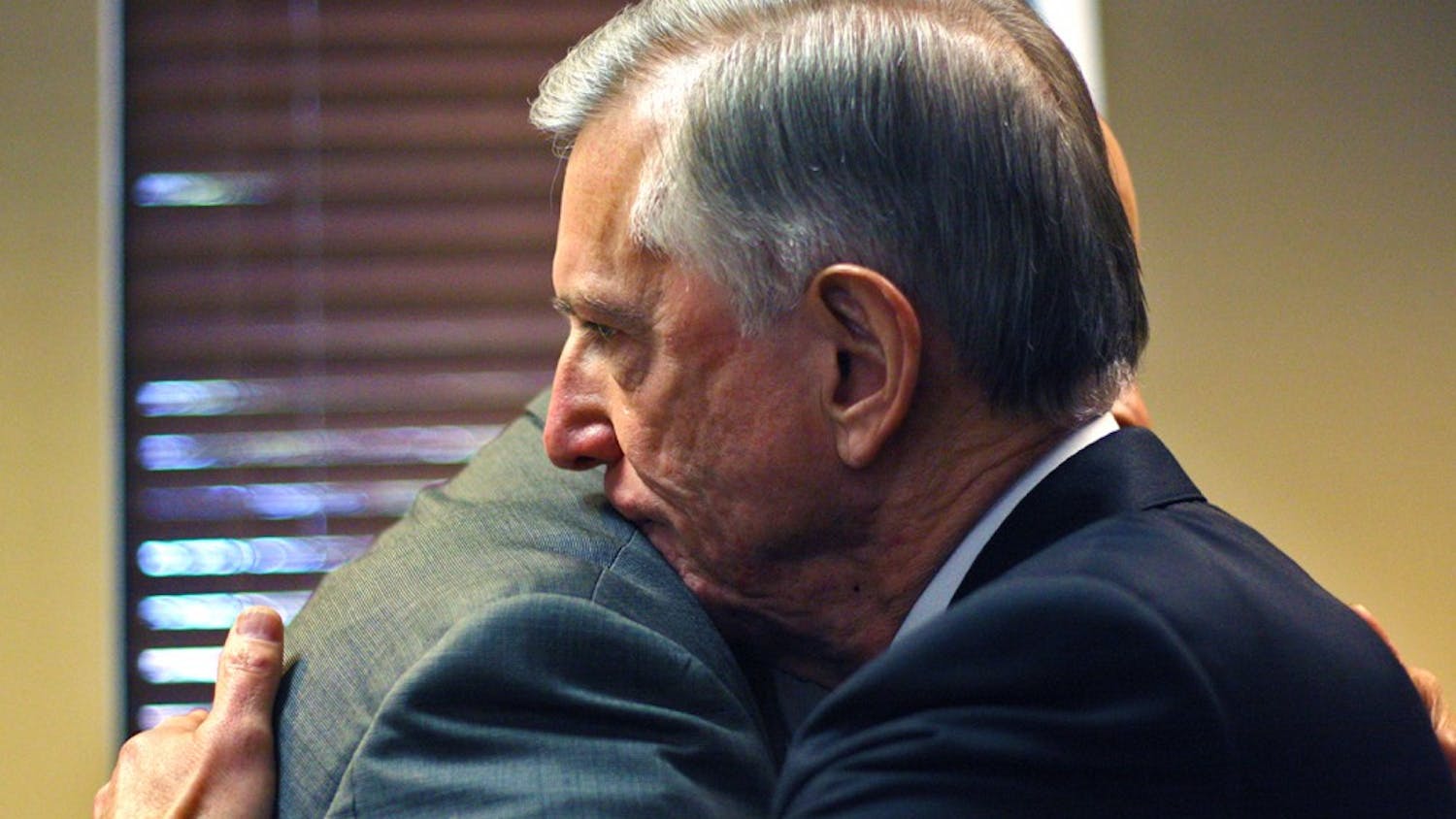 Tom Ross, current UNC-system president, hugs a colleague after a news conference Friday. Ross announced he would be stepping down in January 2016.