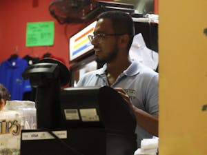 Yeshua Sanchez, a manager at Cosmic Cantina, takes an order in Cosmic on Thursday, July 11, 2019.&nbsp;