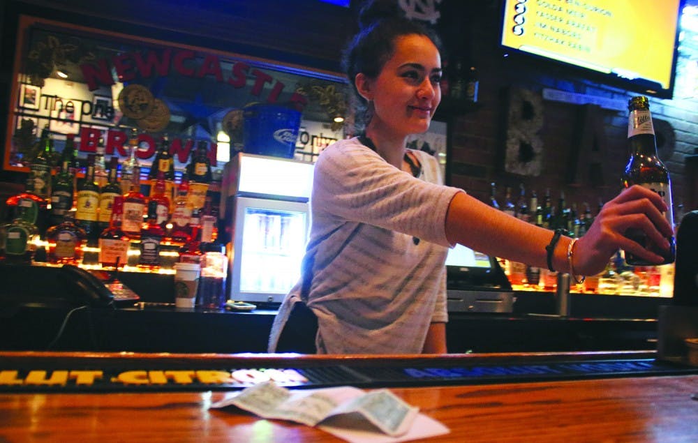 Alex Vasquez works on a tipped wage as a bartender at Four Corners. Recently non-tipped wages have gone up while tipped wages have reined the same.