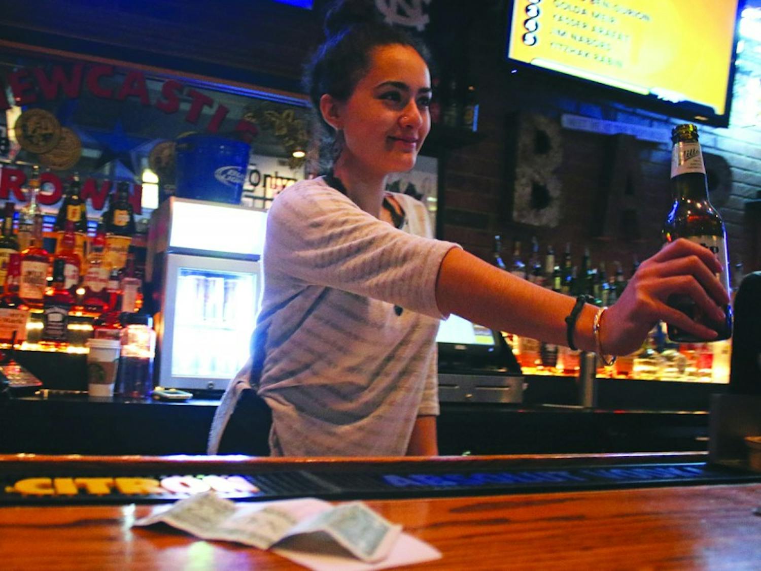 Alex Vasquez works on a tipped wage as a bartender at Four Corners. Recently non-tipped wages have gone up while tipped wages have reined the same.