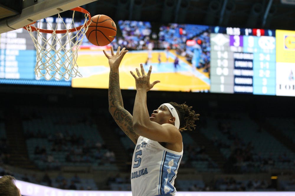 UNC junior forward Armando Bacot (5) finishes at the hoop during a home game at the Dean Smith Center against Furman on Tuesday, Dec. 14, 2021.