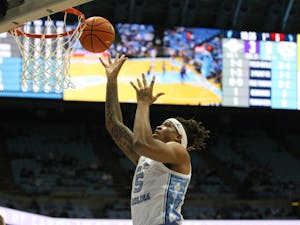 UNC junior forward Armando Bacot (5) finishes at the hoop during a home game at the Dean Smith Center against Furman on Tuesday, Dec. 14, 2021.