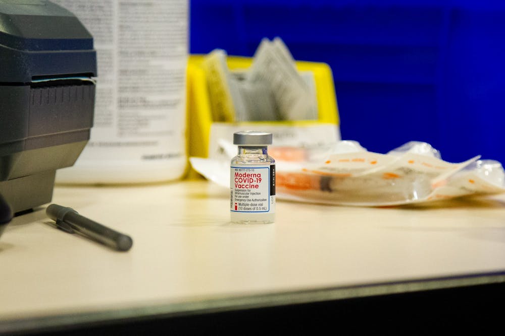 <p>A dose of the Moderna COVID-19 vaccine sits on the desk of a volunteer on Thursday, Jan. 21, 2021 in the Friday Center in Chapel Hill.</p>