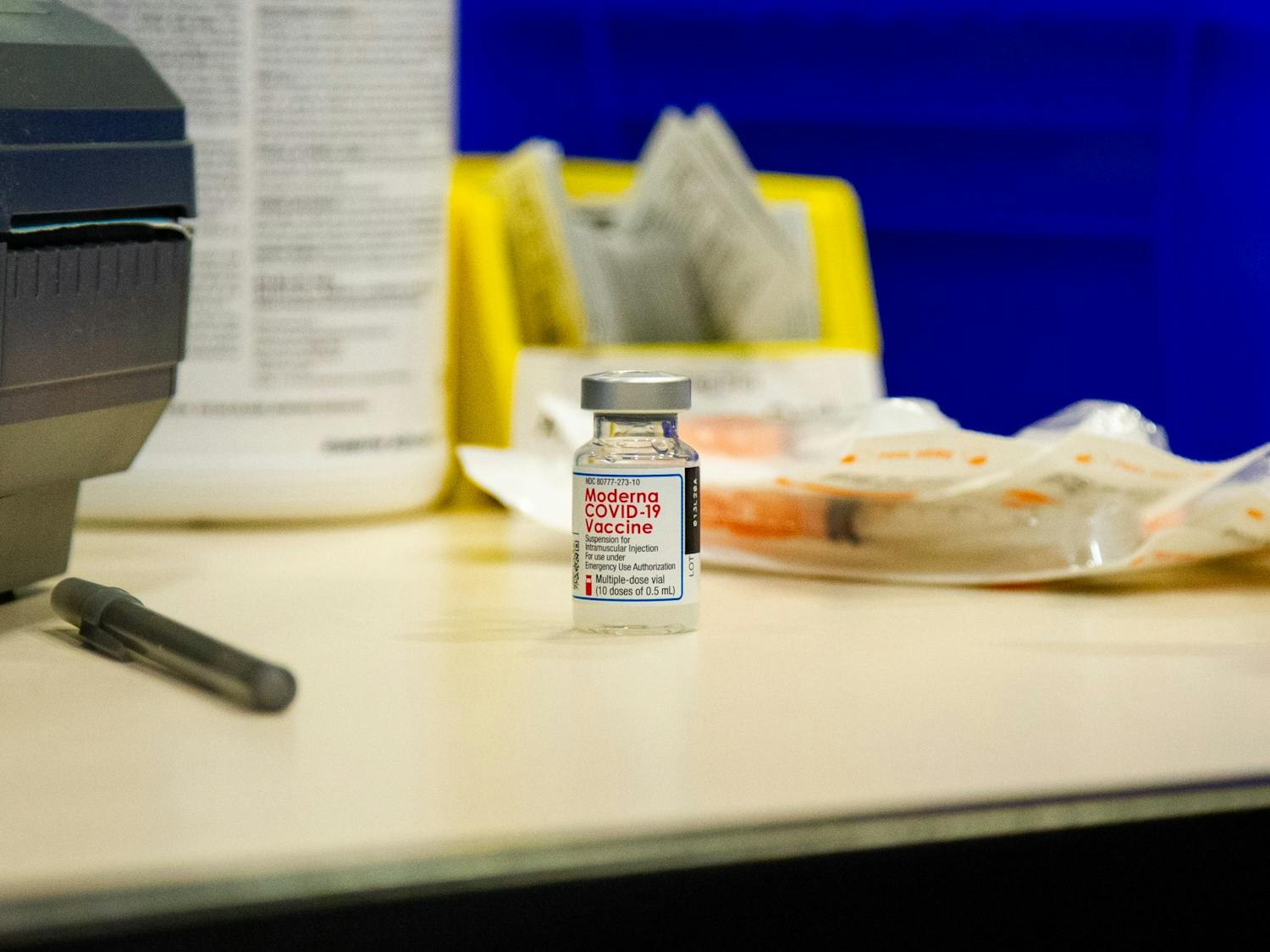 A dose of the Moderna COVID-19 vaccine sits on the desk of a volunteer on Thursday, Jan. 21, 2021 in the Friday Center in Chapel Hill.