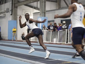 Cameron Douglas, junior sprinter for UNC, reaches for the baton as he starts his sprint during the Men 4x400 Relay in the Dick Taylor Carolina Cup at Eddie Smith Field House on Saturday, Jan. 13, 2019. The Tar Heels won the relay with a time of 3:16.88.&nbsp;