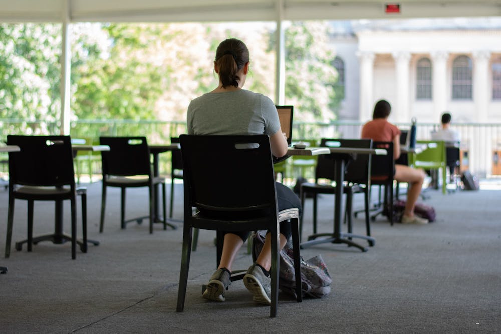 A student works at the newly implemented pavilion in Polk Place on Sunday, Sep. 6, 2020. Due to the COVID-19 pandemic, students are taking advantage of different study spaces around campus.