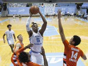 North Carolina's Armando Bacot (5) drives to the basket against Syracuse's Alan Griffin (0) and Jesse Edwards (14) in the first half on Tuesday, January 12, 2021 at the Smith Center in Chapel Hill, NC. Photo courtesy of Robert Willett.