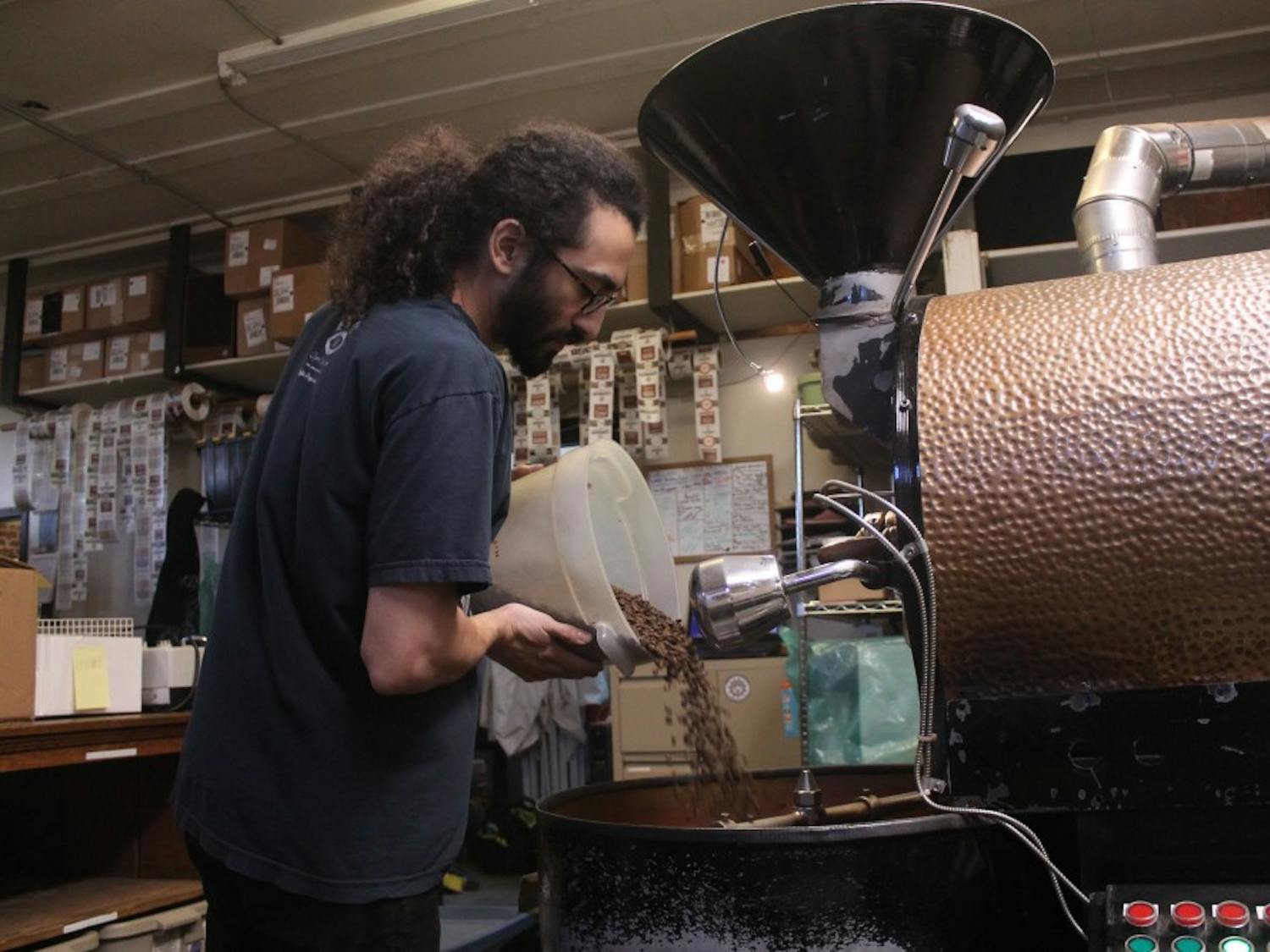 Carrboro Coffee Roaster's employee, David Ruiz, works on roasting coffee for Open Eye Cafe on the afternoon of Wednesday, Jan. 16, 2019. Carrboro Coffee Roasters is one of the many companies in Orange County that are an Orange County Certified Living Wage Employer.