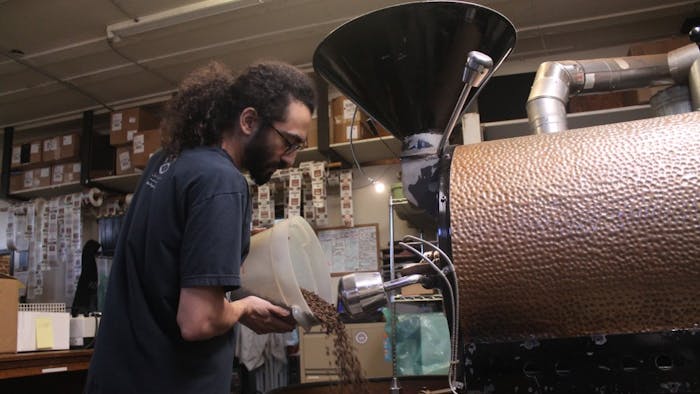 Carrboro Coffee Roaster's employee, David Ruiz, works on roasting coffee for Open Eye Cafe on the afternoon of Wednesday, Jan. 16, 2019. Carrboro Coffee Roasters is one of the many companies in Orange County that are an Orange County Certified Living Wage Employer.
