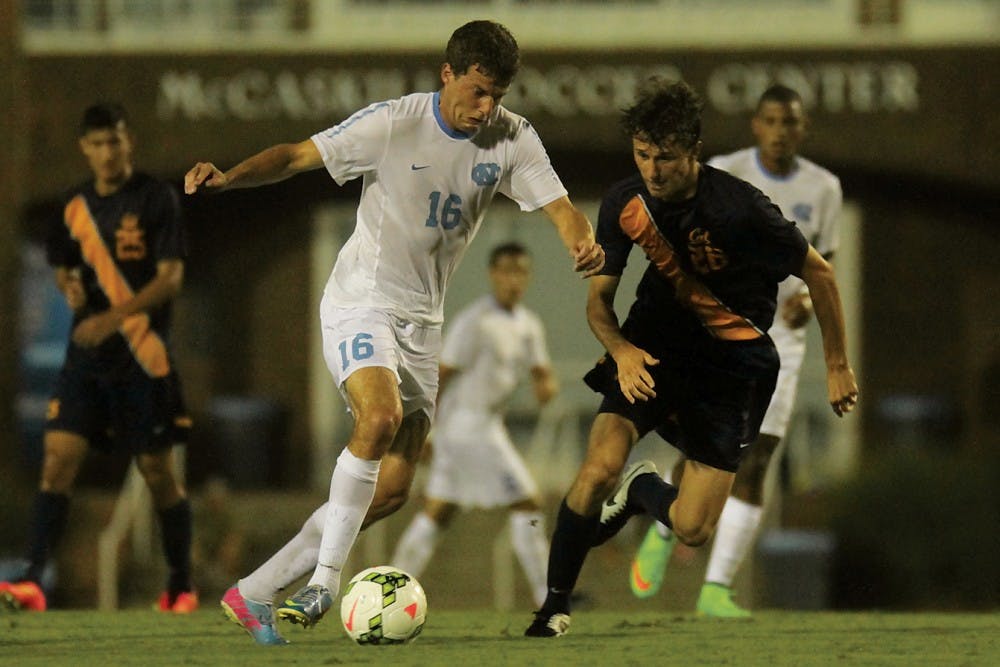 Rob Lovejoy attempts to make room between himself and California defender Ugo Rebecchini.  He would go on to score a goal in UNC’s 3-1 victory Friday.