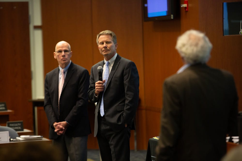 <p>(From left) Provost Robert Blouin and Chancellor Kevin Guskiewicz listen as Lloyd Kramer, chair of the faculty, speaks at a Faculty Governance Meeting in Kerr Hall on Friday, Dec. 6, 2019. Guskiewicz discussed the intention to move forward in regard to race on campus following a Board of Governors-sanctioned settlement of $2.5 million dollars with the Sons of Confederate Veterans.</p>
