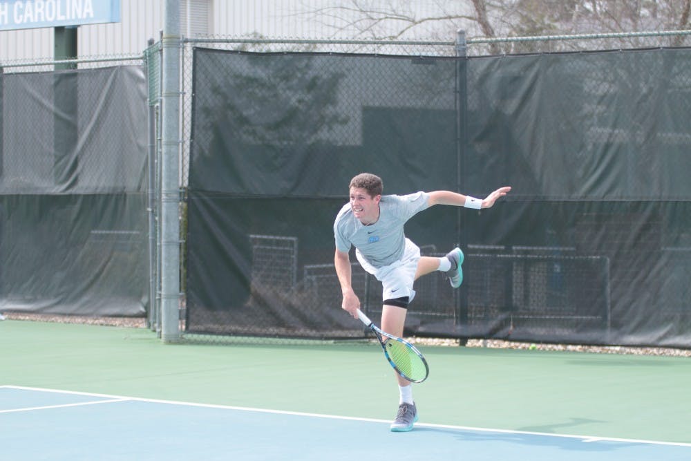 <p>Junior Blaine Boyden follows through on a serve against Wake Forest on March 28 at the Cone-Kenfield Tennis Center.</p>
