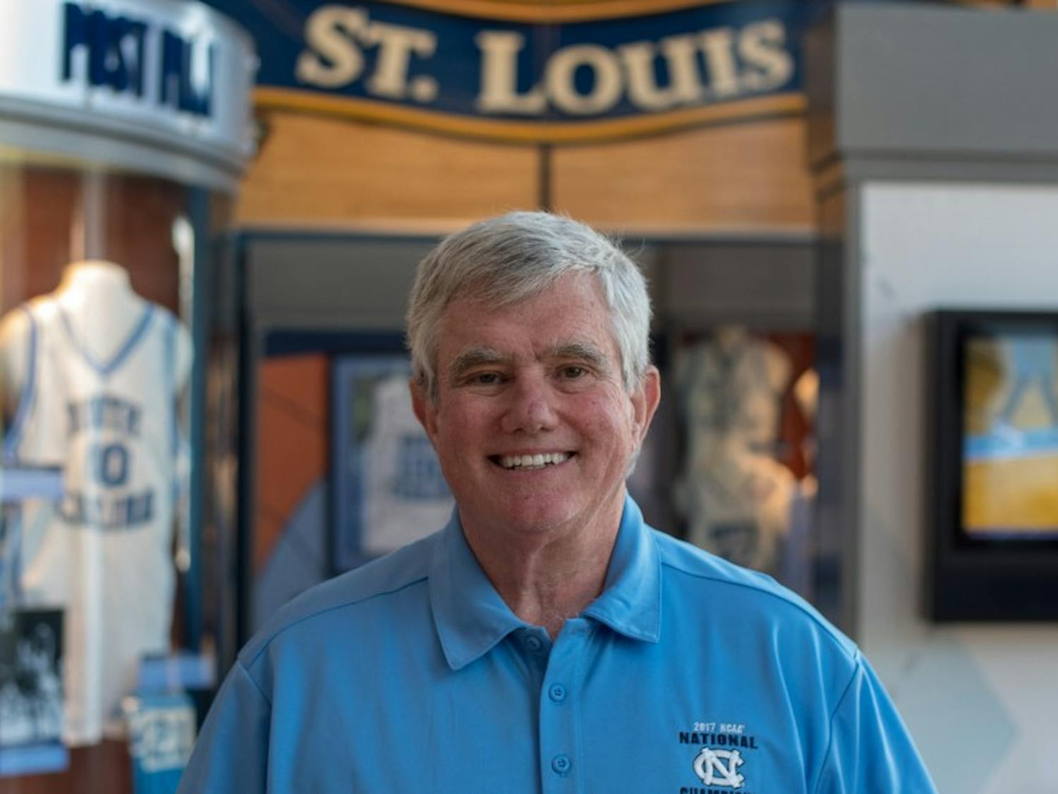 Bob Ward stands inside the Carolina Basketball Museum where he has worked as an attendant and greeter since 2008. Ward is a lifelong resident of Chapel Hill and has been a regular usher at UNC basketball games for 35 years.