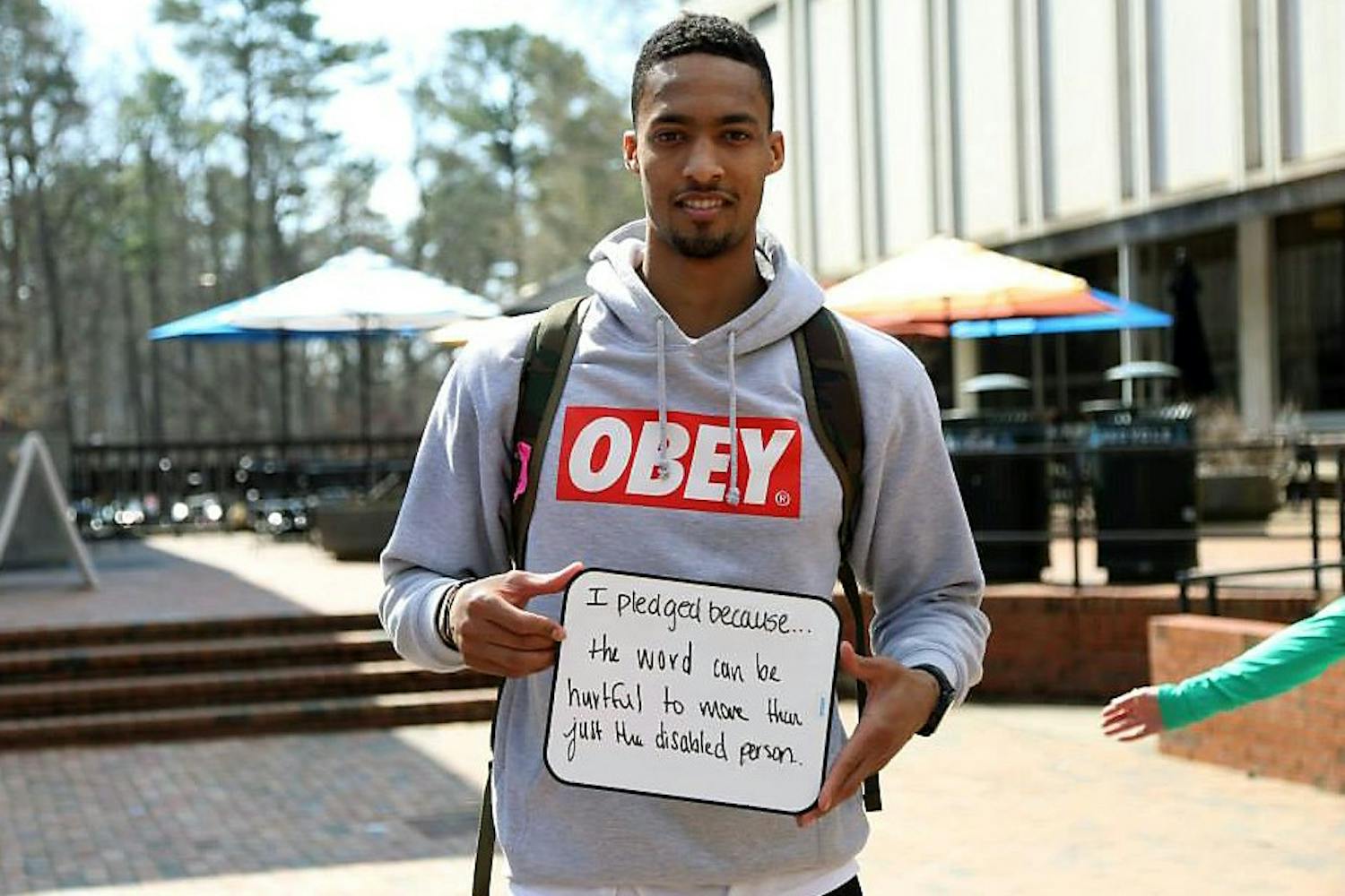 Sophomore forward on the men's basketball team J.P. Tokoto signed the Spread the Word to End the Word pledge in the Pit on Monday.Courtesy of Anisha Parker.