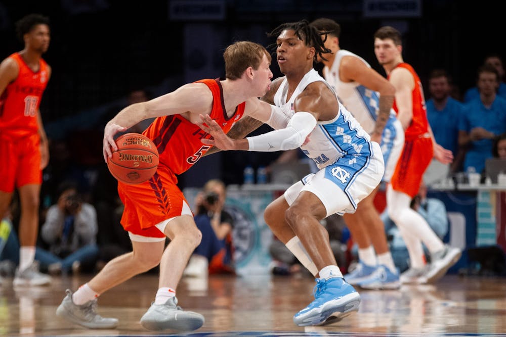 <p>Sophomore guard Caleb Love (2) defends a Virginia Tech player during the semifinals of the ACC tournament at the Barclays Center on March 11, 2022.</p>