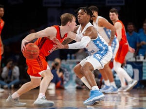 Sophomore guard Caleb Love (2) defends a Virginia Tech player during the semifinals of the ACC tournament at the Barclays Center on March 11, 2022.